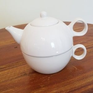 Tea pot with cup beneath